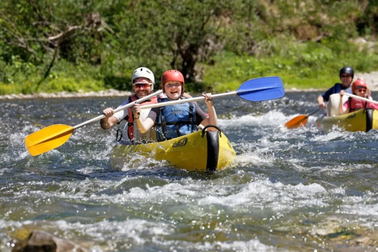 Dad and son kayaking on a single parent adventure holiday in the south of France